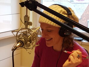 Wedding Planner Zoe Binning talking into a studio microphone